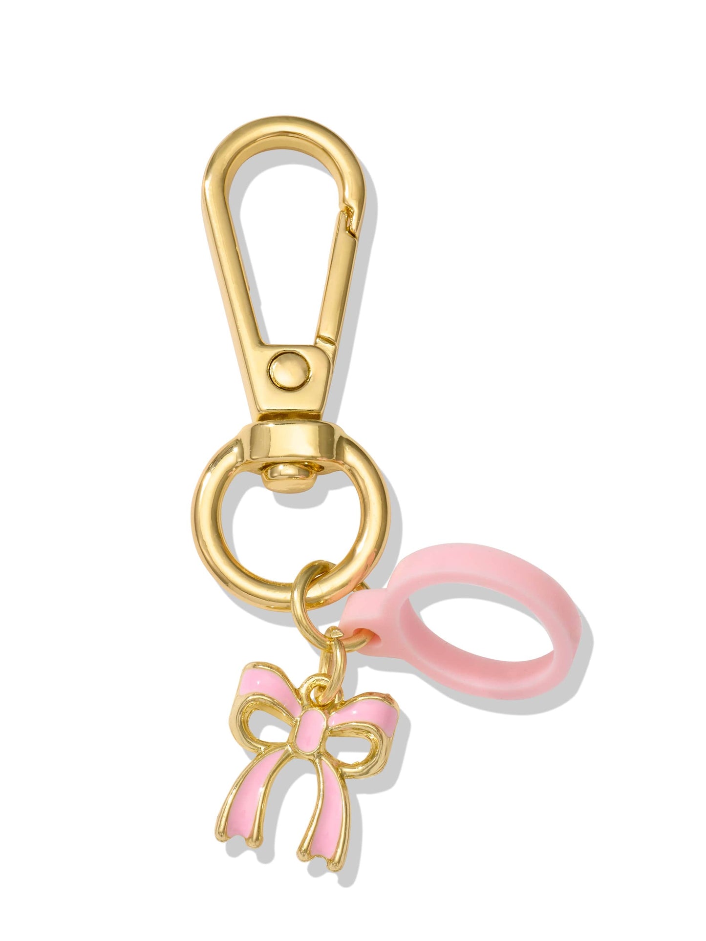 A gold keychain clip supports a pink and gold bow charm and a pink circular loop, against a plain white background.