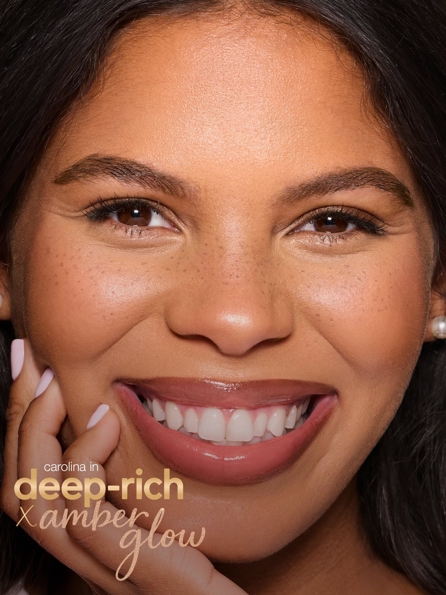 Close-up of a woman's face with 'Carolina Herrera Deep Rich Amber Glow' makeup. using tarte cosmetics freckle stick