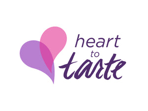 Two overlapping hearts, one pink and one purple, appear to the left of the text heart to tarte in stylized purple font on a white background.