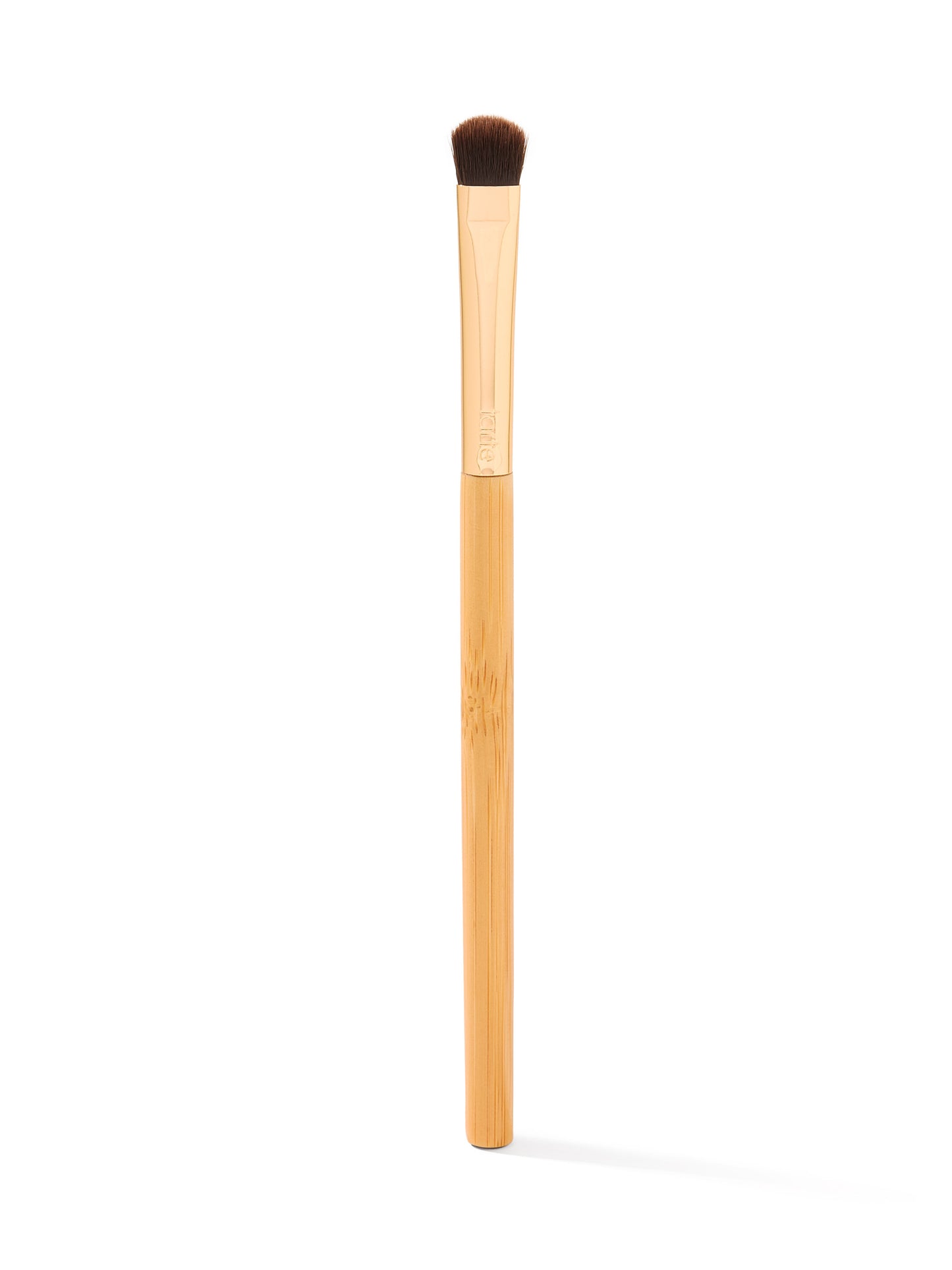 Makeup brush with wooden handle and brown bristle head on a white background
