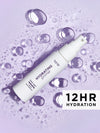 Hydrating primer bottle with water droplets on a purple background