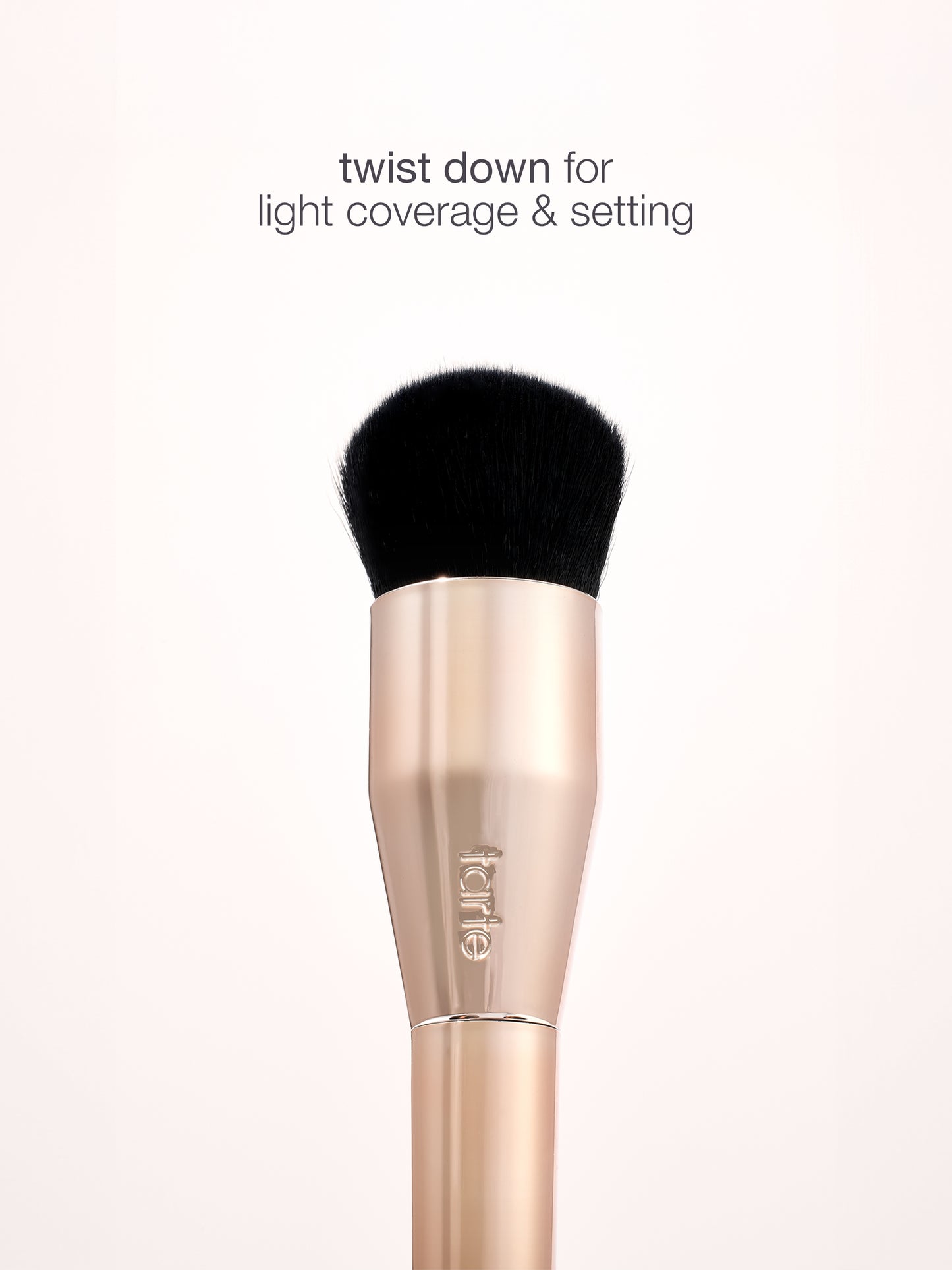 Makeup brush with black bristle tip on a white background, featuring the brand 'e.l.f.'