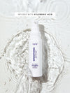 Tarte smoothing primer bottle with hyluronic acid text on a white background