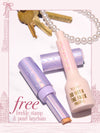 Tarte Shape Tape Blur Stick and Tarte Go With The Faux Freckle bottle, alongside a pearl keychain and keys on a white background and text reading 'free freckle stamp & pearl keychain'.