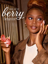 woman using tarte cosmetics XOXO blush and go in shade berry behavior