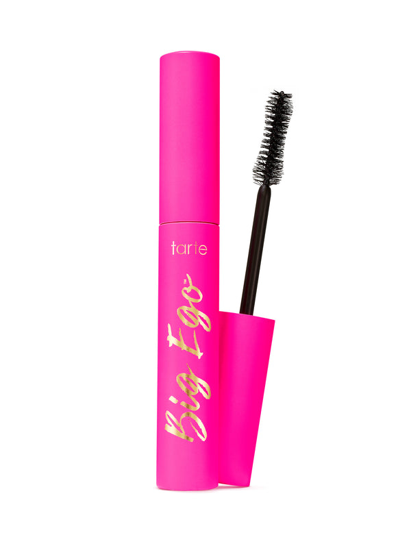 Tarte Big Ego mascara in a bright pink tube with gold script lettering, shown with the black applicator wand and a matching pink cap on a white background.