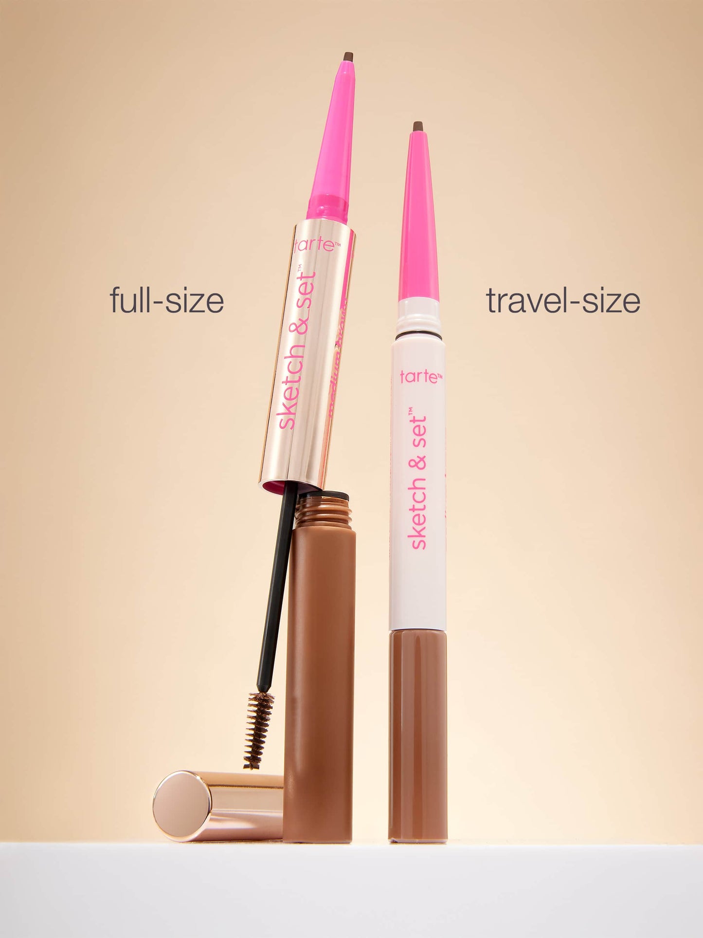 Full-size and travel-size makeup products on a beige background