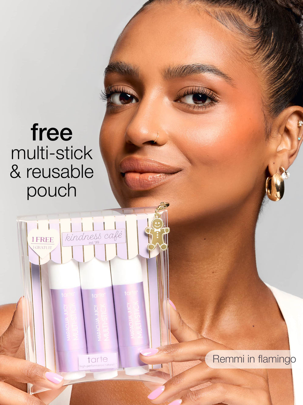 Woman holding a makeup product with text about a free multi-stick & reusable pouch offer.