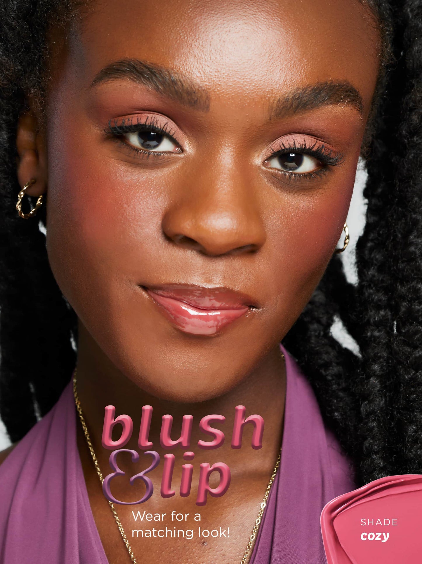 Woman with makeup products labeled 'blush & lip' and 'Shade Cozy'.