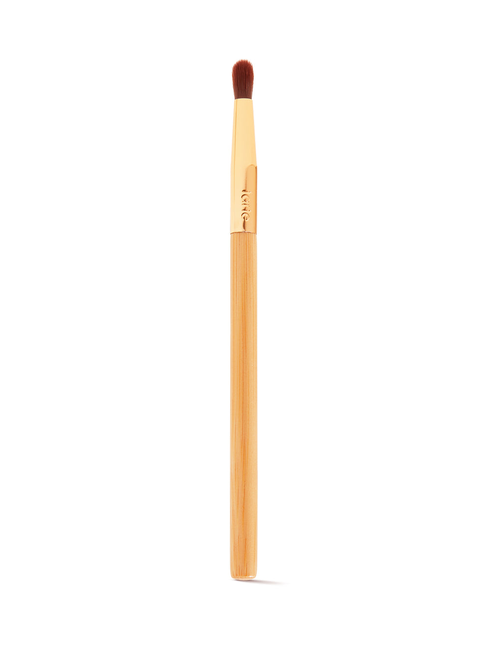 A makeup brush with a wooden handle and soft, dense bristles is positioned vertically against a plain white background. The gold ferrule is engraved with tarte.