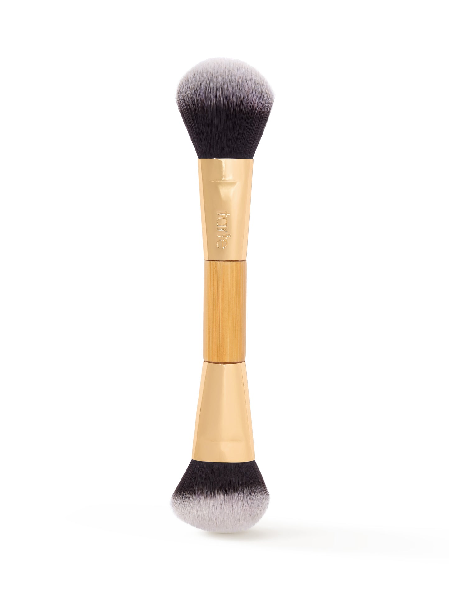 Dual-ended makeup brush featuring soft, dense bristles for application, with a gold-tone ferrule displaying tarte branding; placed vertically against a plain white background.