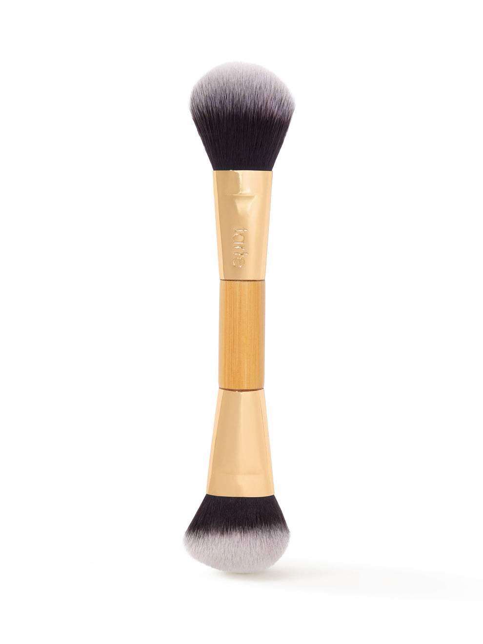 Dual-ended makeup brush featuring soft, dense bristles for application, with a gold-tone ferrule displaying tarte branding; placed vertically against a plain white background.