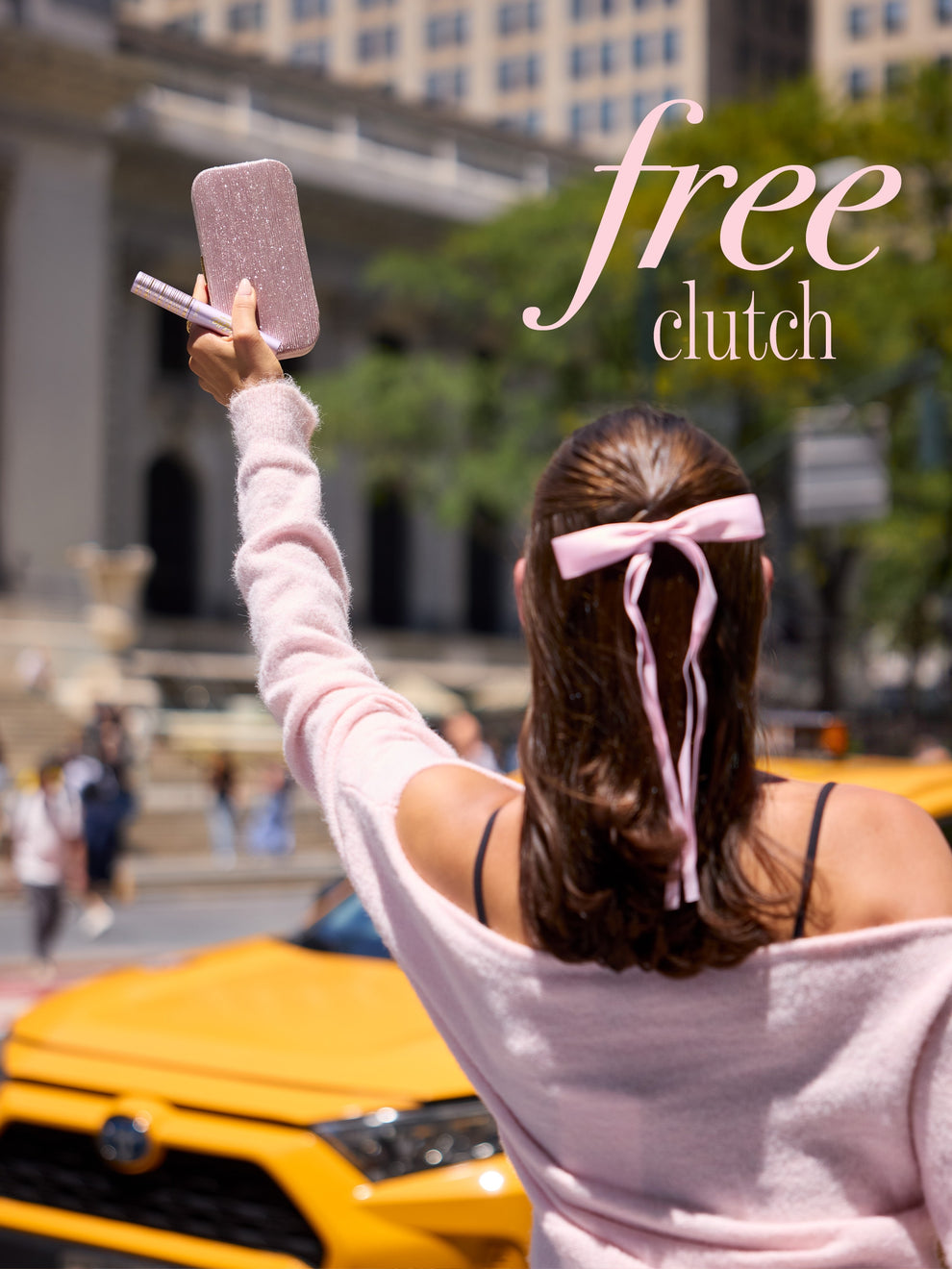 woman holding tarte cosmetics eyes on me mascara liner &  free clutch