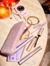 tarte cosmetics eyes on me mascara liner & clutch on a table, all products coming out of the clutch