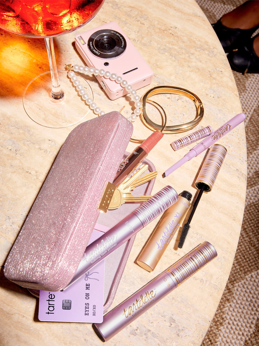 tarte cosmetics eyes on me mascara liner & clutch on a table, all products coming out of the clutch