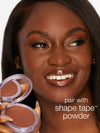 woman holding tarte cosmetics shape tape pressed powder