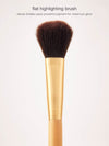 Cosmetic brush with gold handle and brown bristles on a white background
