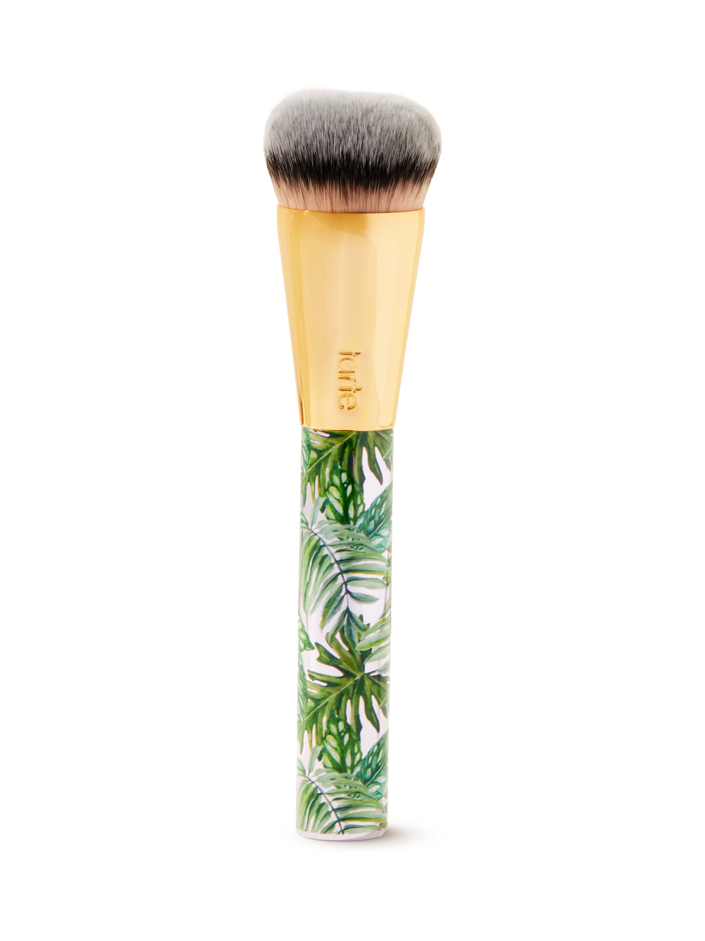 Makeup brush with tropical leaf design handle on a white background