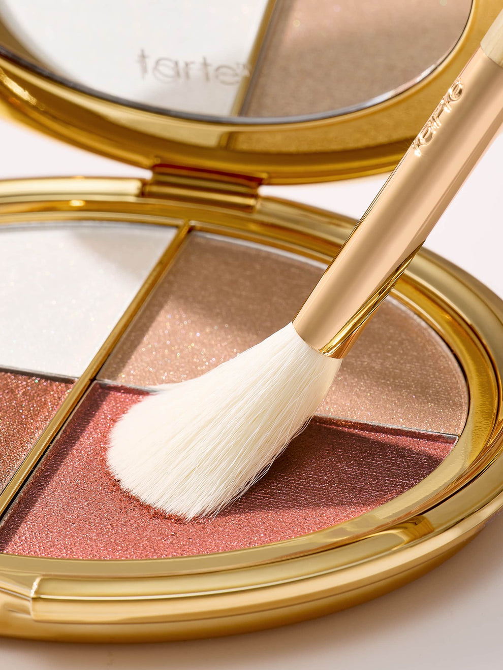 Makeup compact with blush and a brush, featuring the Tarte logo.