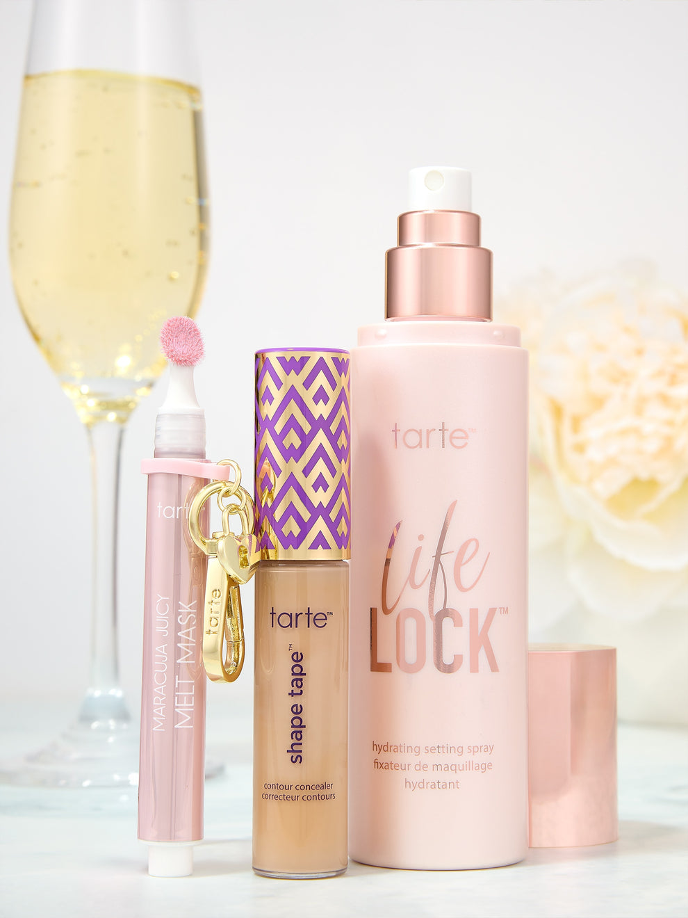 Tarte skincare and makeup products on a white surface with a blurred background