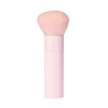 A tarte cosmetics pink makeup brush with soft, rounded bristles and a pink handle, on a white background. 