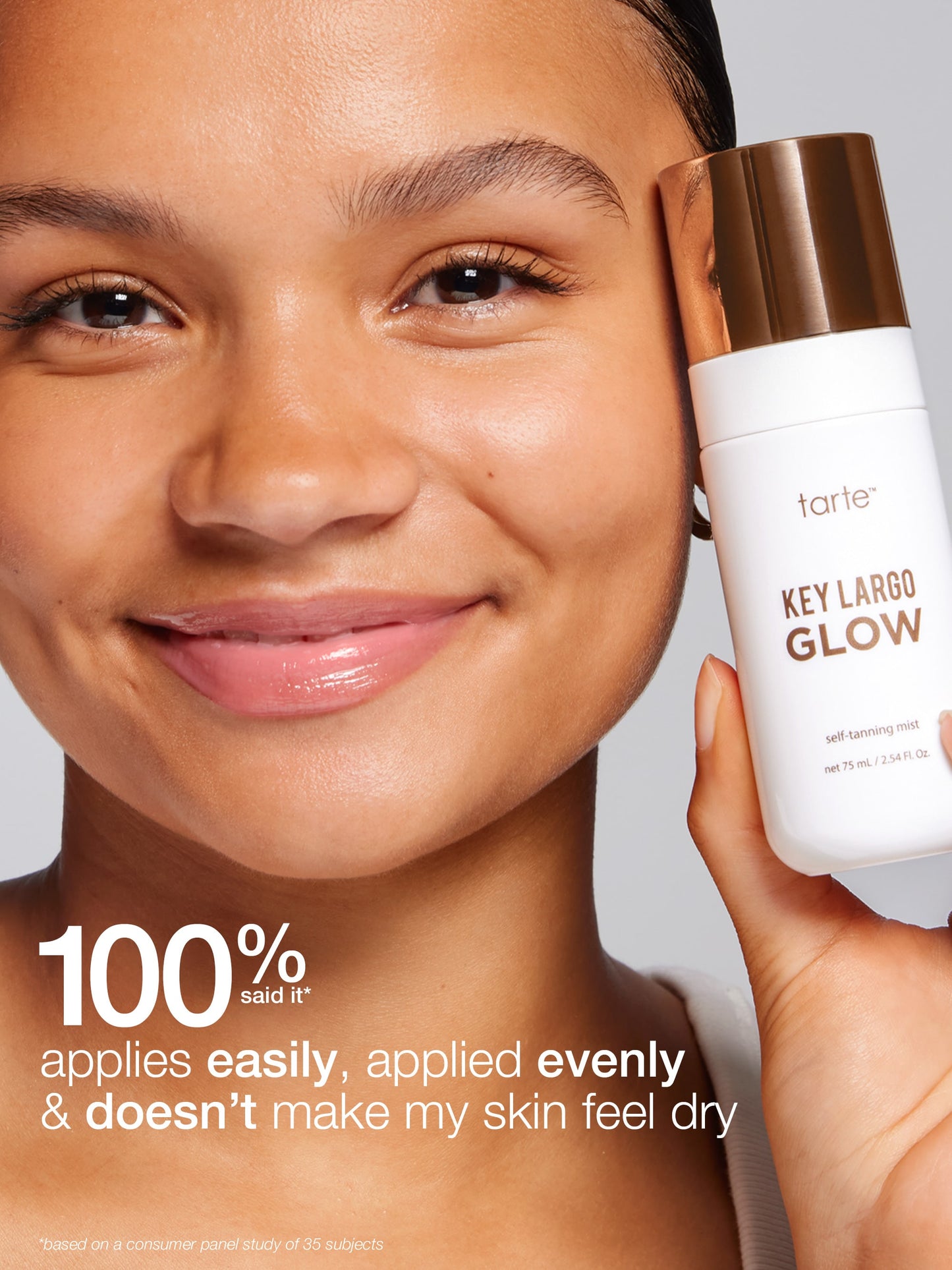 Person holding a tarte Key Largo Glow product with a neutral background