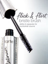 Mascara brush extending from a shiny tube labeled tarte platinum. Text reads: flick & flirt bristle brush define & separate for bombshell volume. Set against a metallic background.