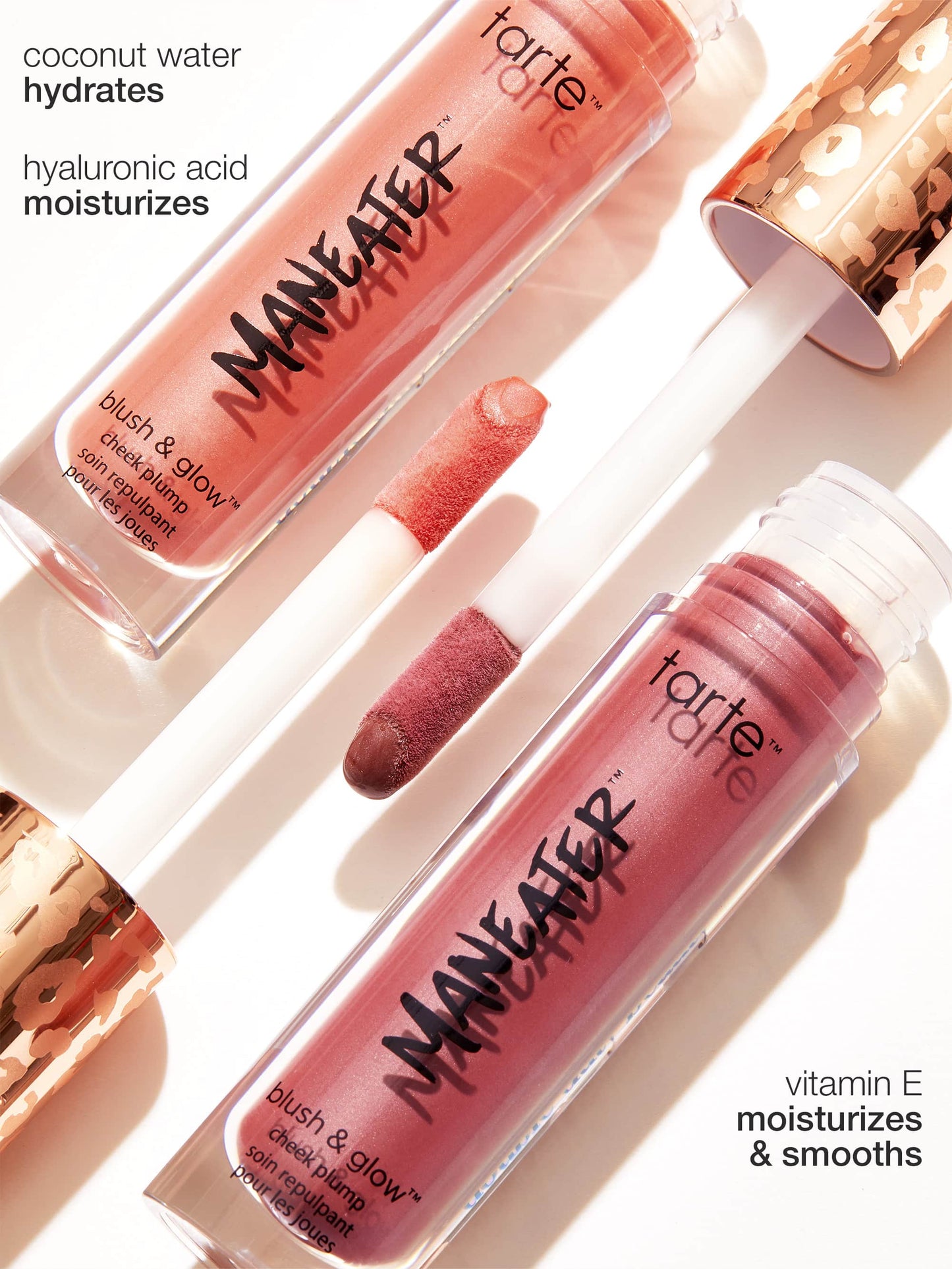 Two tubes of Tarte Cosmetics Maneater blush & glow cheek plump with wand applicators displayed on a bright surface. Text highlights ingredients: coconut water hydrates, hyaluronic acid moisturizes, vitamin E moisturizes & smooths.