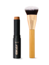 Tarte maneater foundation stick and foundation brush on a light background
