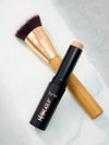 Tarte maneater foundation stick and foundation brush on a light background