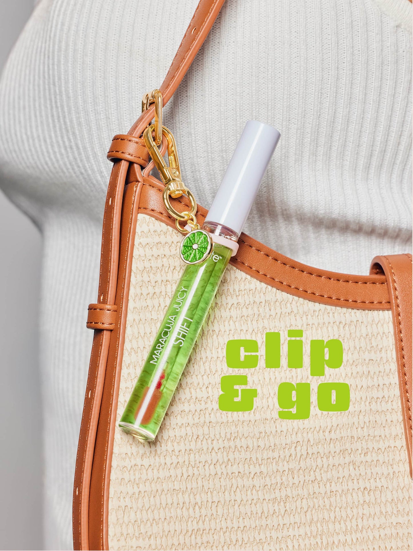 Green lip balm with a clip attached to a beige bag with 'clip & go' text.