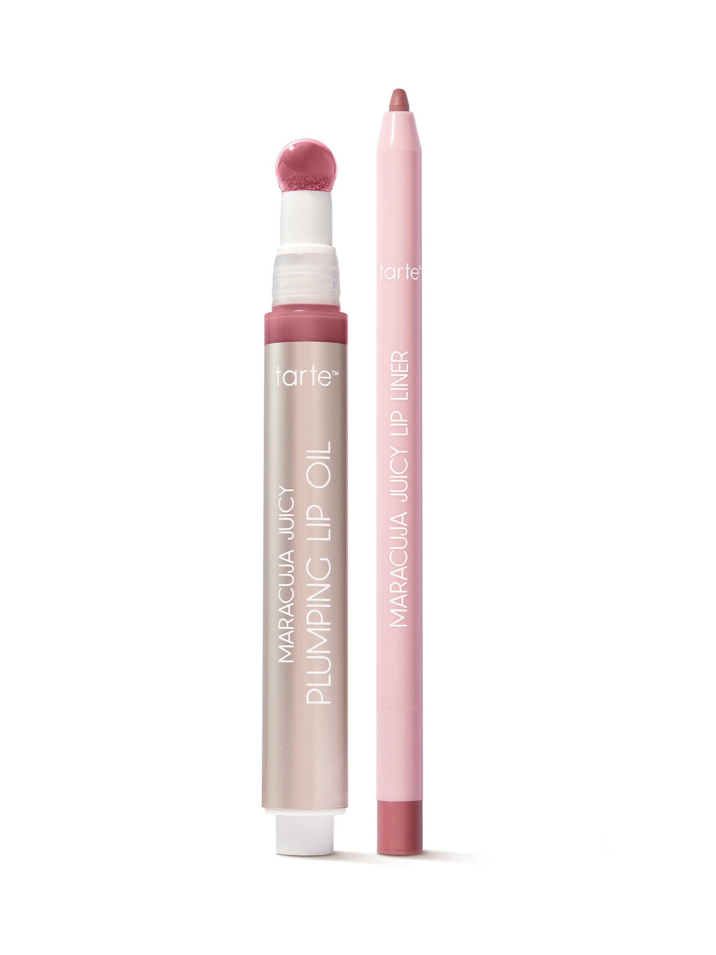 Lip oil and liner in pink, stand upright on a white surface. The oil features a sponge applicator; text reads tarte, MARACUJA JUICY PLUMPING LIP OIL, and MARACUJA JUICY LIP LINER.