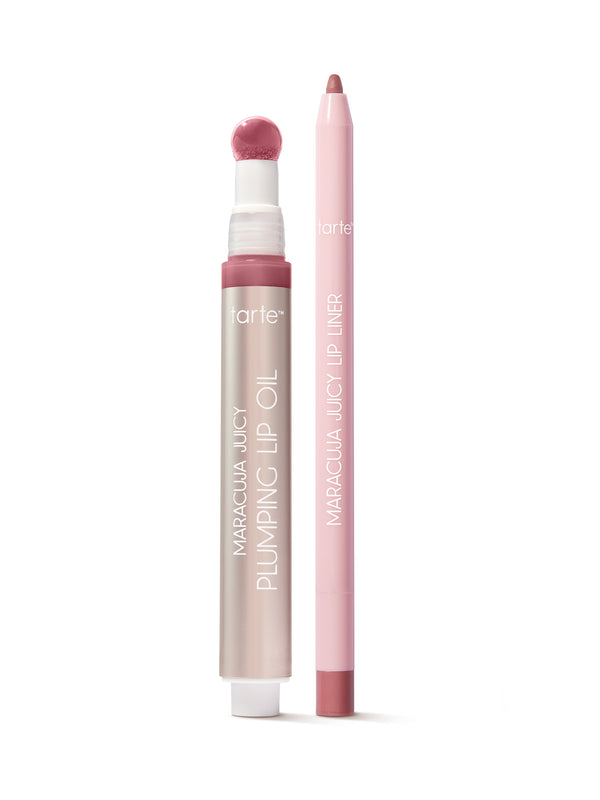Lip oil and liner in pink, stand upright on a white surface. The oil features a sponge applicator; text reads tarte, MARACUJA JUICY PLUMPING LIP OIL, and MARACUJA JUICY LIP LINER.