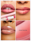 Lips are showcased in various shades of pink with gloss applied. A lip liner and applicator feature prominently. Background includes smooth pink texture with text: mixed berries.