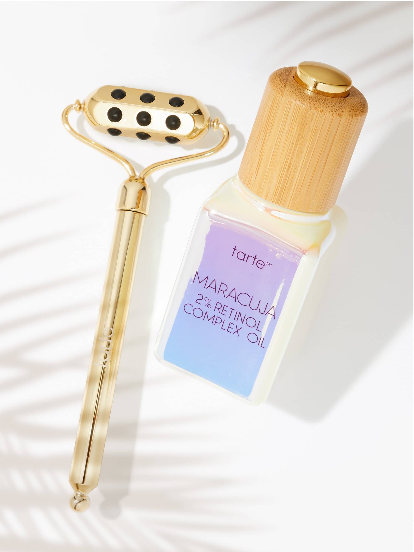Tarte Maracuja 2% Retinol Complex Oil bottle with gold roller on a white background