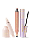 Three Tarte makeup items: a pale-pink faux-lash adhesive bottle with applicator exposed, a shimmery peach smolderEYES eye crayon, and a lavender-gold mascara tube with wand on a white background.

Text: tarte™ GO WITH THE FAUX; tarte™ smolderEYES™; tartelette