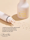 Five-prong freckle stamp presses tiny pigment dots beside a Tarte Go With The Faux bottle on beige paper, creating scattered faux freckles. Text: tarte™ GO WITH THE FAUX I CREATED THIS FIVE-POINT FRECKLE STAMP TO GIVE YOU EFFORTLESS FRECKLE CLUSTERS IN FIVE SECONDS. IT'S THE ULTIMATE LAZY GIRL HACK Maureen Kelly FOUNDER & CEO