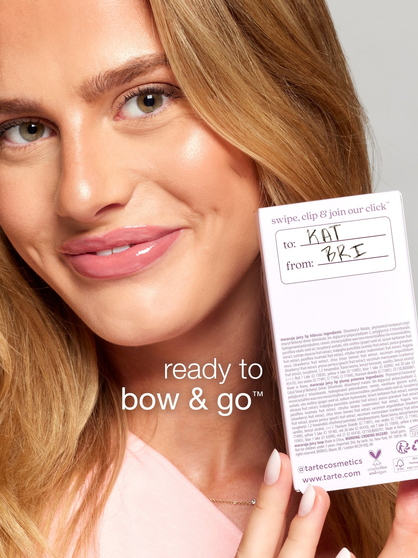 Woman holding a cosmetic product packaging with text on it