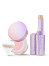 Tarte cushion compact and lavender stick stand together: compact lid open showing pink powder and puff; stick extended revealing beige product on white background. Text: tarte; shape tape BLUR