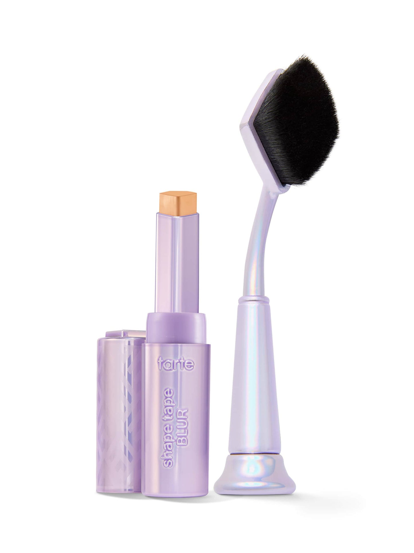 Makeup stick with applicator and brush on a white background
