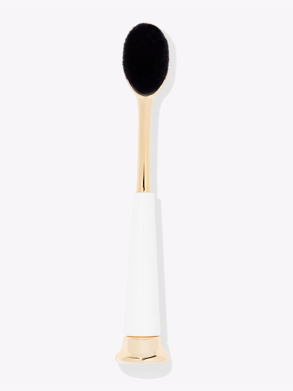Makeup brush with black bristle head and gold and white handle on a white background