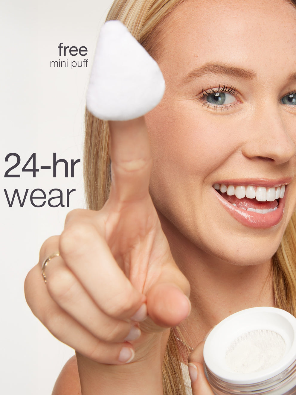 Woman holding a skincare product with a free mini puff offer on a white background