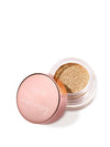 A small jar of shimmering gold eyeshadow with an open rose-gold lid. The lid features the text tarte x amber massey. The jar rests on a white background.