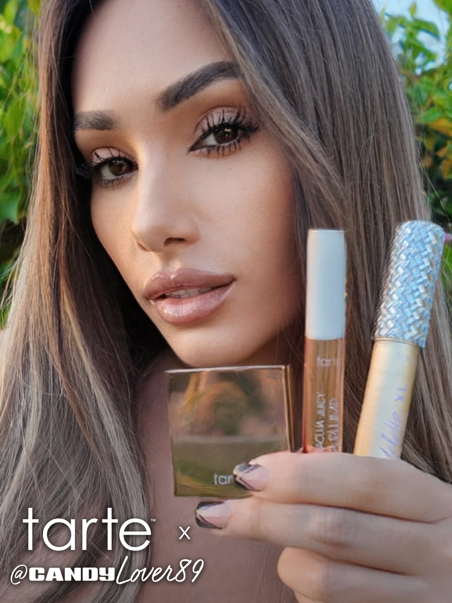A person holds three Tarte Cosmetics products, displaying them closely to the camera. They are outdoors with greenery in the background. Text reads: tarte ™ x @CANDYLOver89.