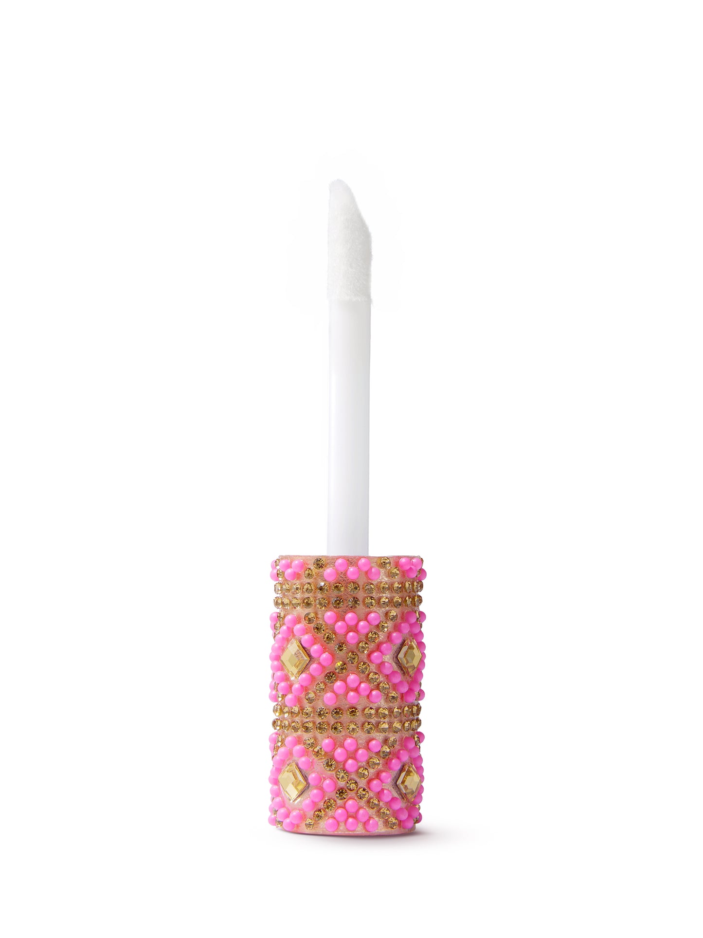 A white wand with a textured tip stands upright, emerging from a decorative, jewel-encrusted pink and gold cap, set against a plain white background.