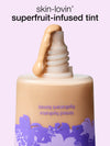 Superfruit-infused tint bottle with a dropper on a light purple background