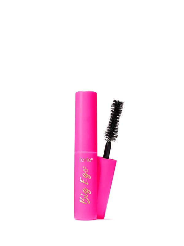 A bright pink tube of Tarte Big Ego mascara with its wand removed and standing beside it, on a clean white background.