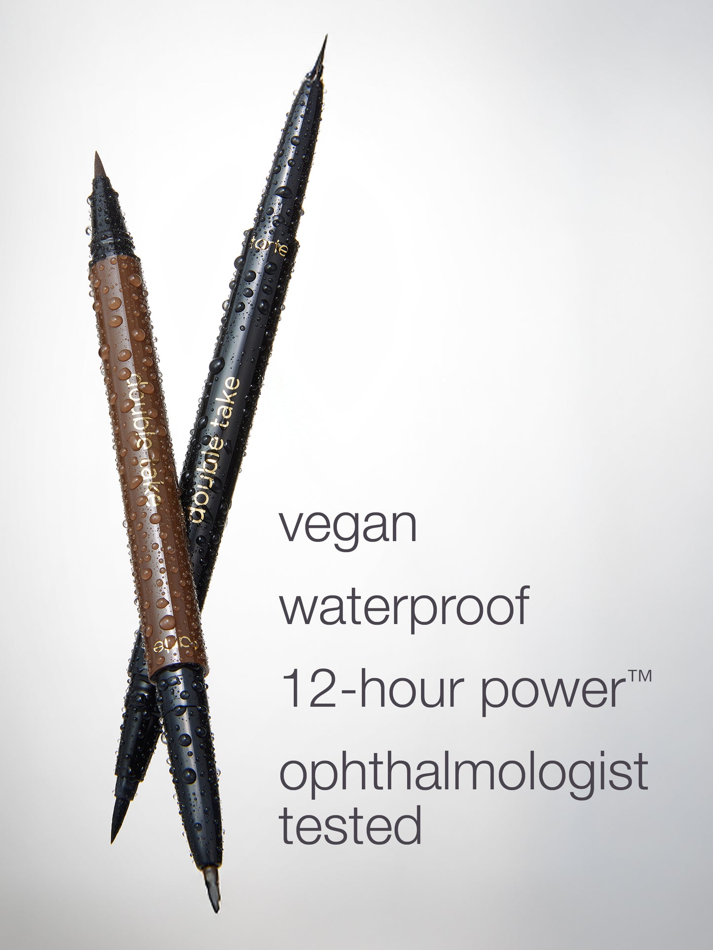 Two cosmetic pencils, one brown and one black, covered in water droplets on a light gray background, with text reading 'vegan waterproof 12-hour power ophthalmologist tested'.