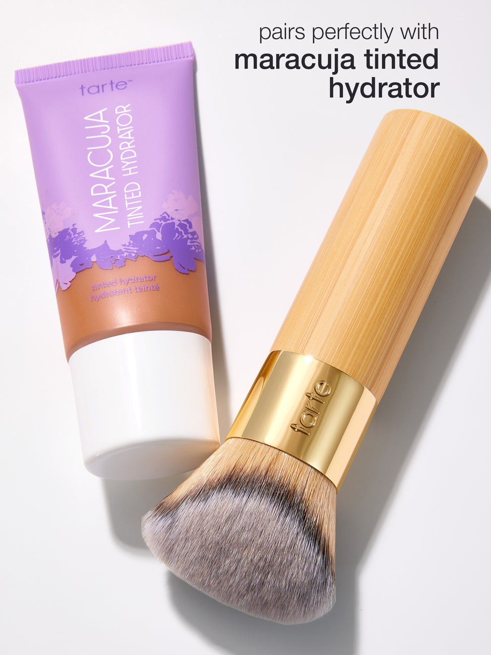 Tarte Maracuja tinted hydrator and brush on a white background