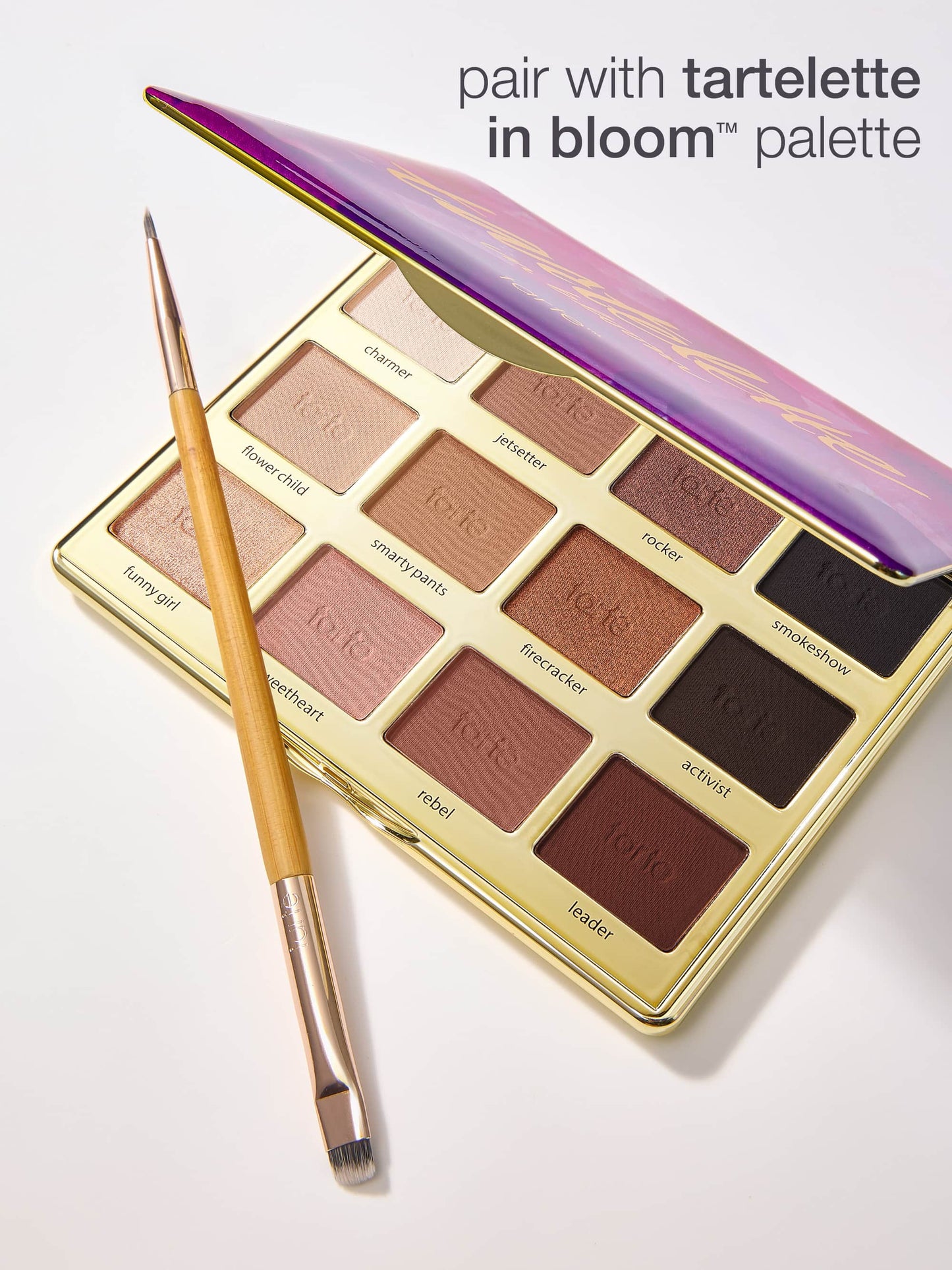 Makeup palette with brush labeled 'tartelette in bloom' on a white background